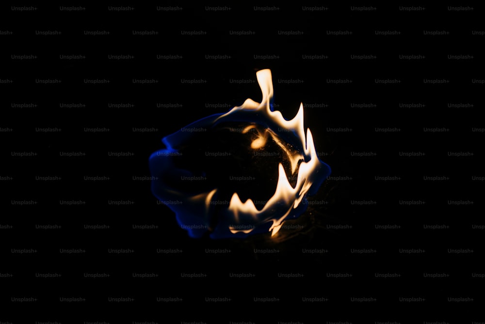 a black background with a blue flame in the middle