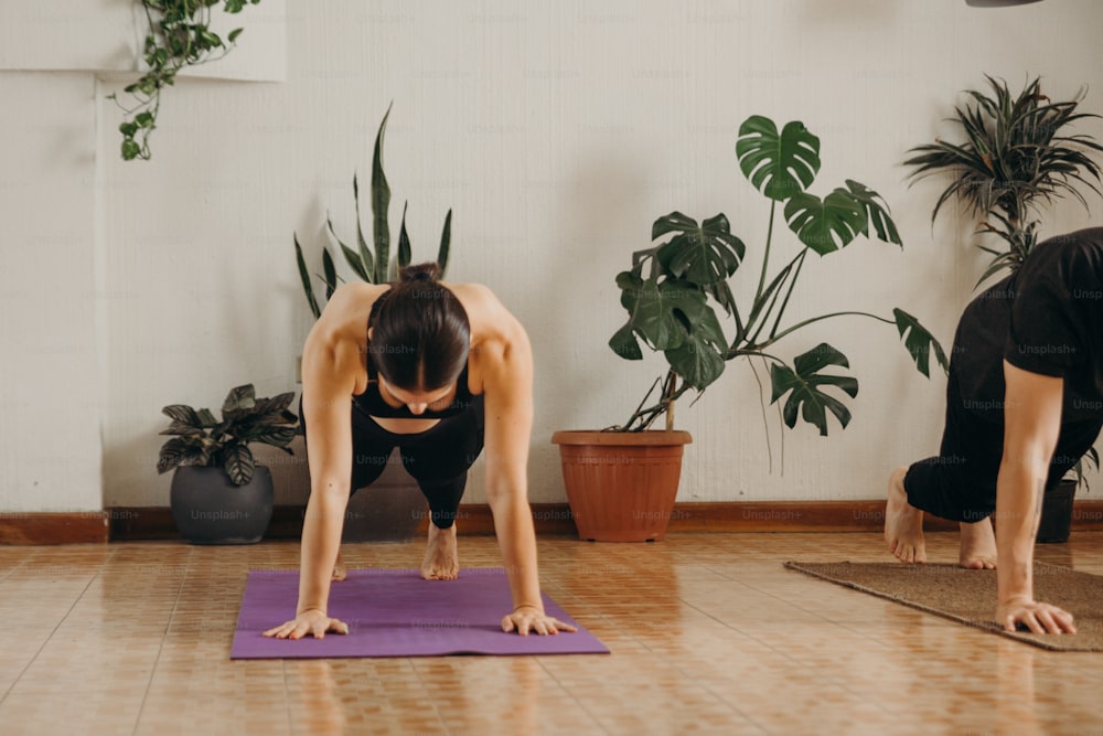 two women are doing yoga in a room