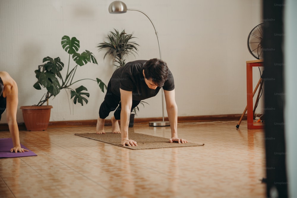 a man and a woman doing yoga in a room
