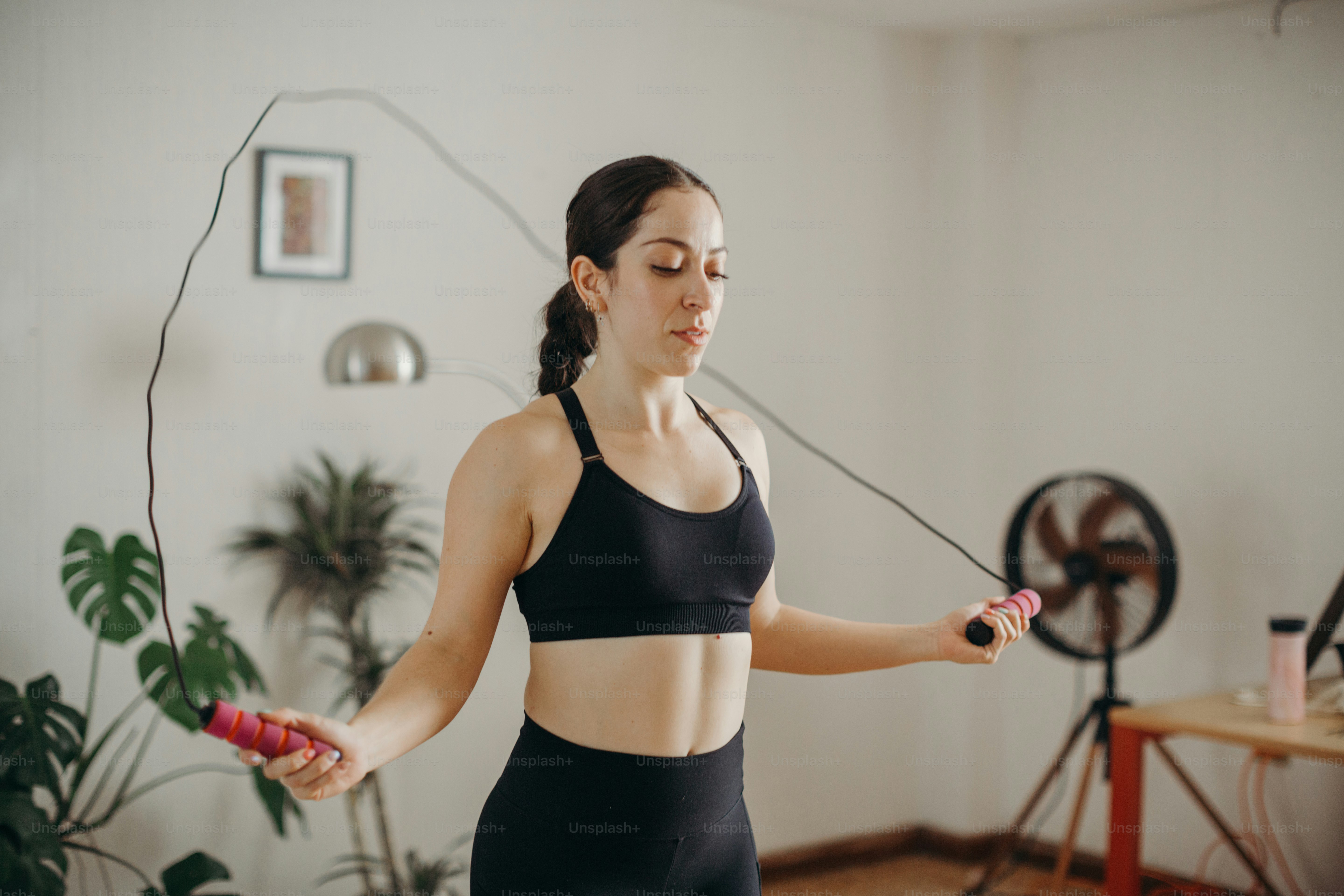 A woman in a sports bra top holding a skipping rope photo – Sweaty ...
