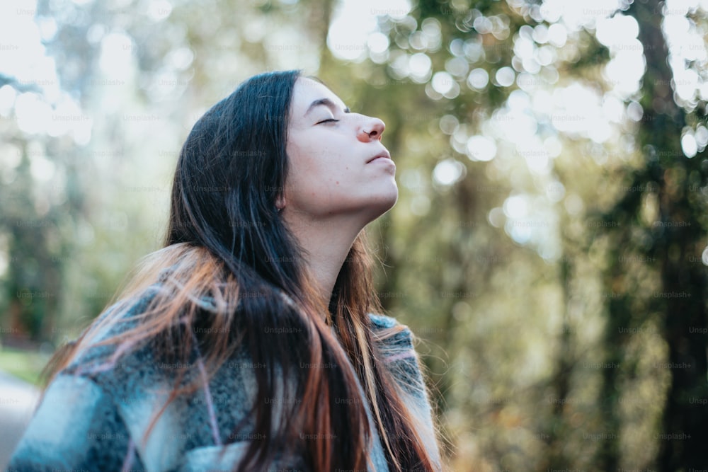 a woman with long hair looking up into the sky