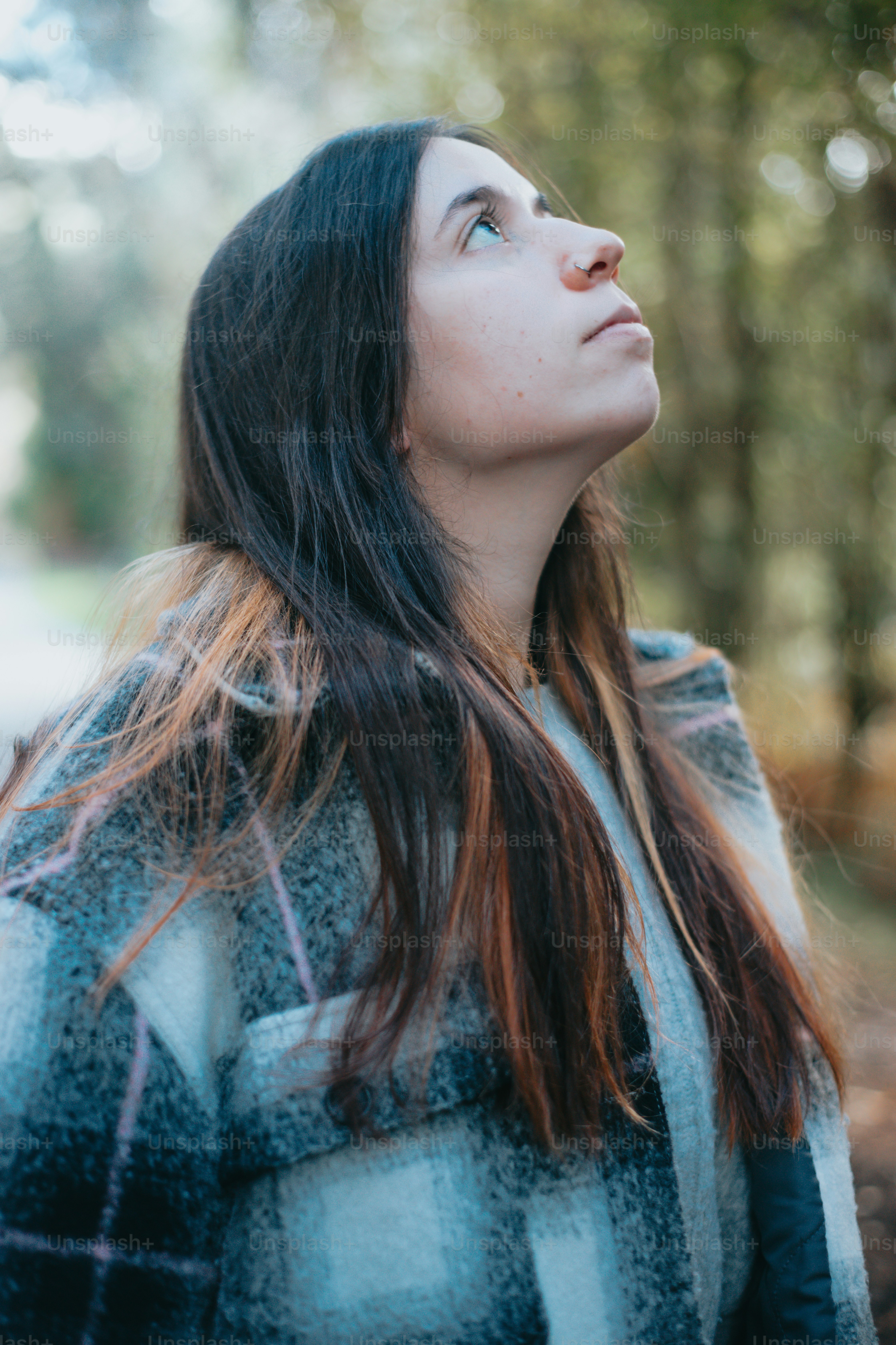 a woman with long hair looking up into the sky