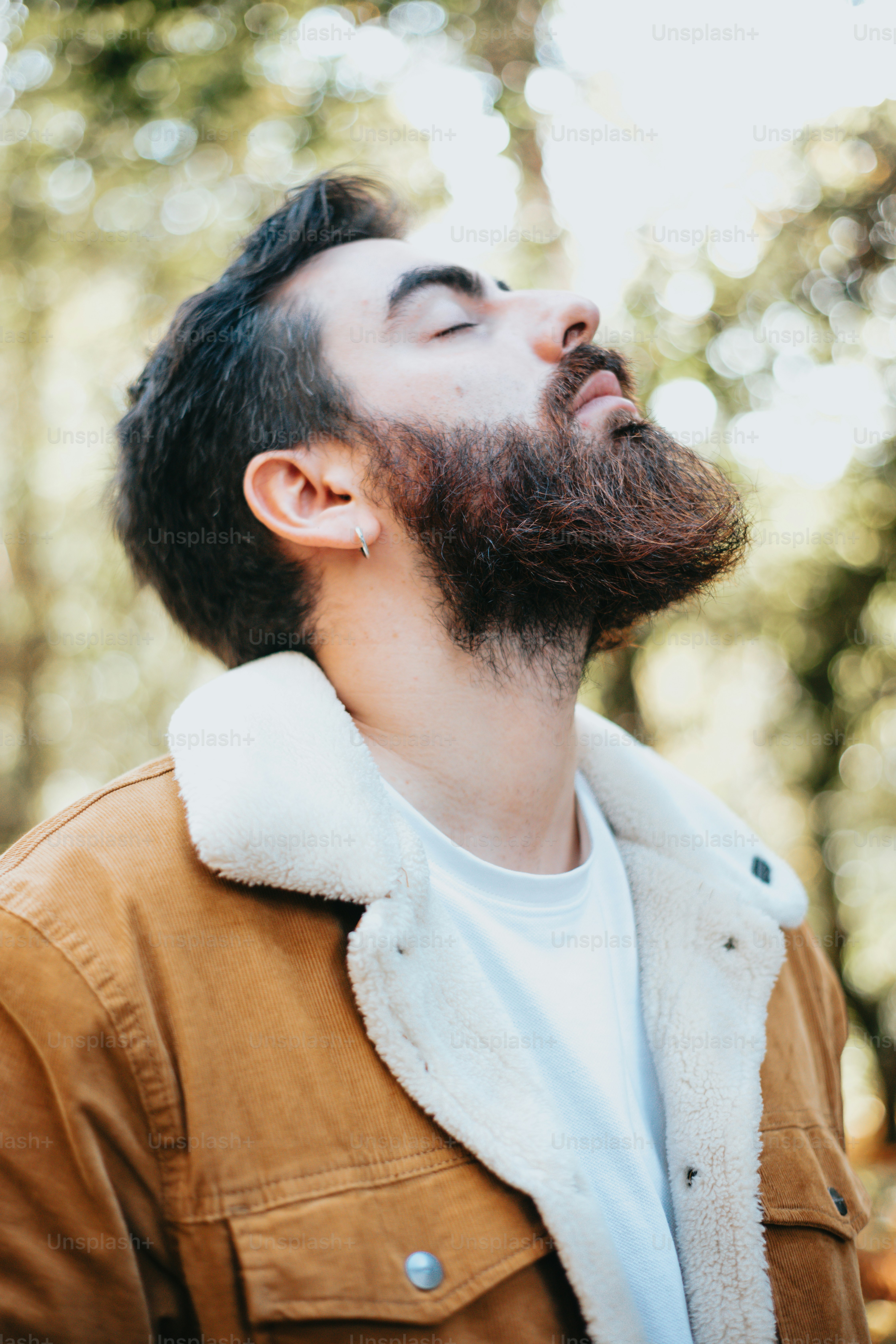 a man with a beard is looking up into the sky