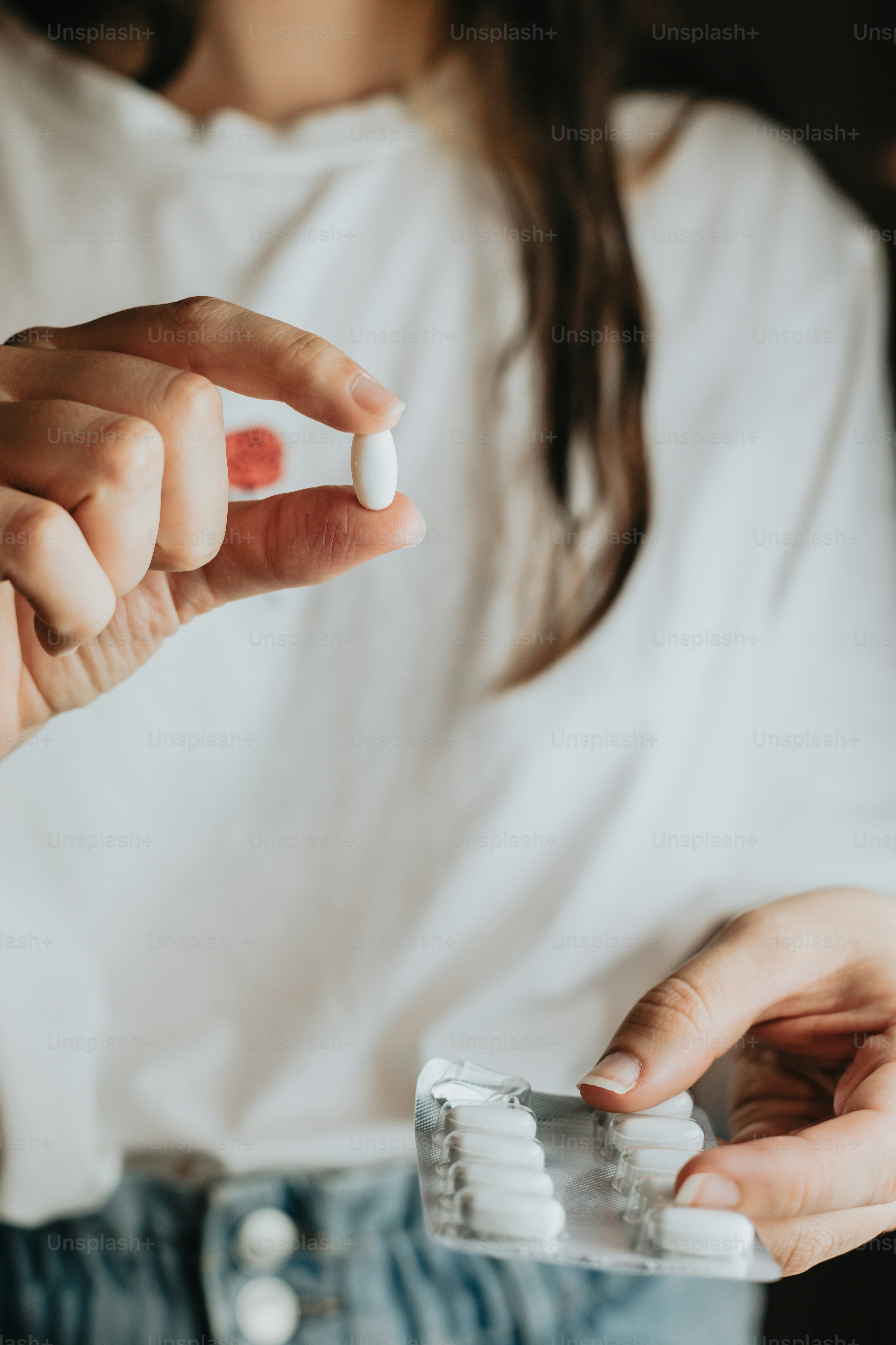 ピルボトルとピルのパックを持っている女性