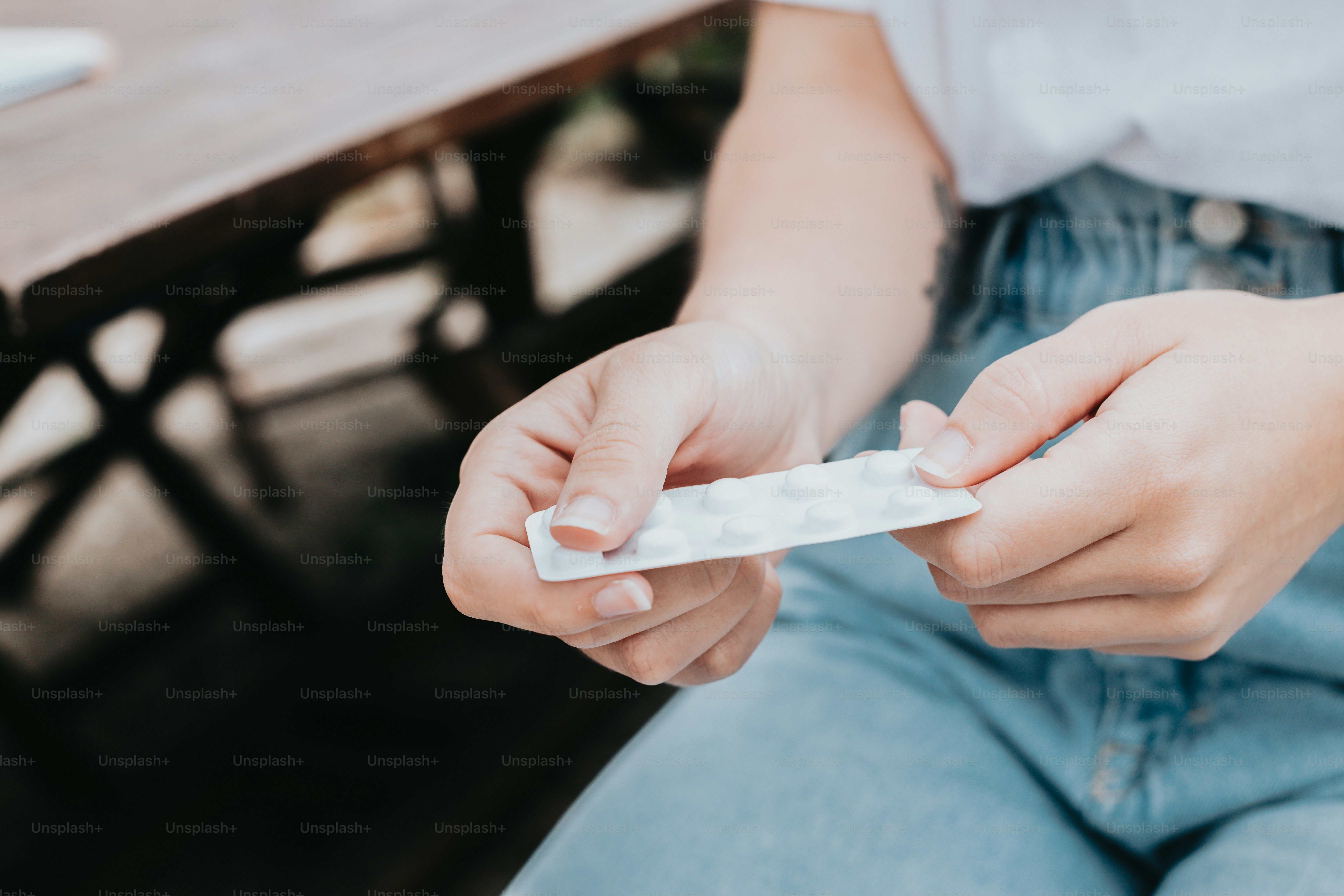 a person is holding a condom in their hand
