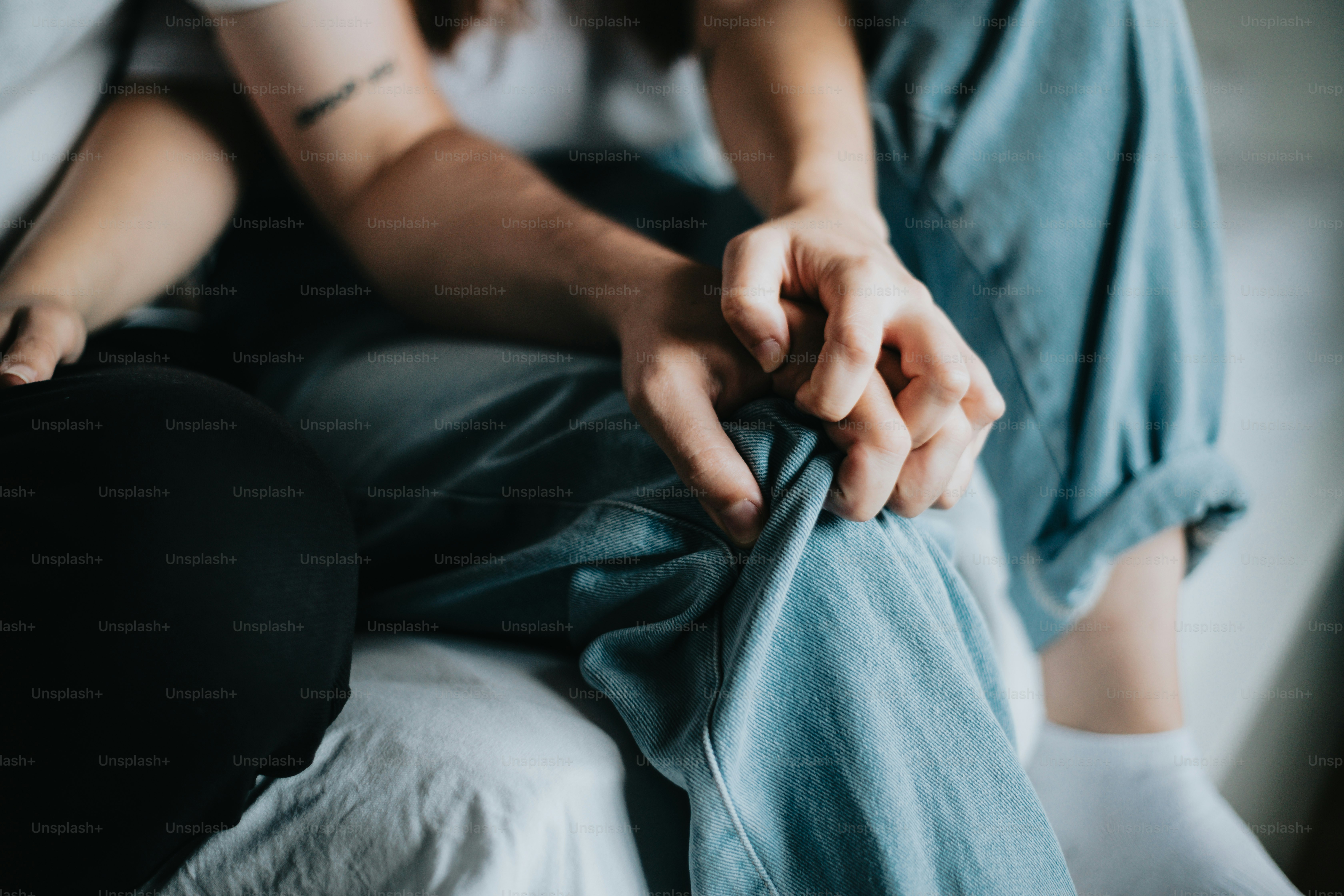 a woman sitting on top of a bed next to a man