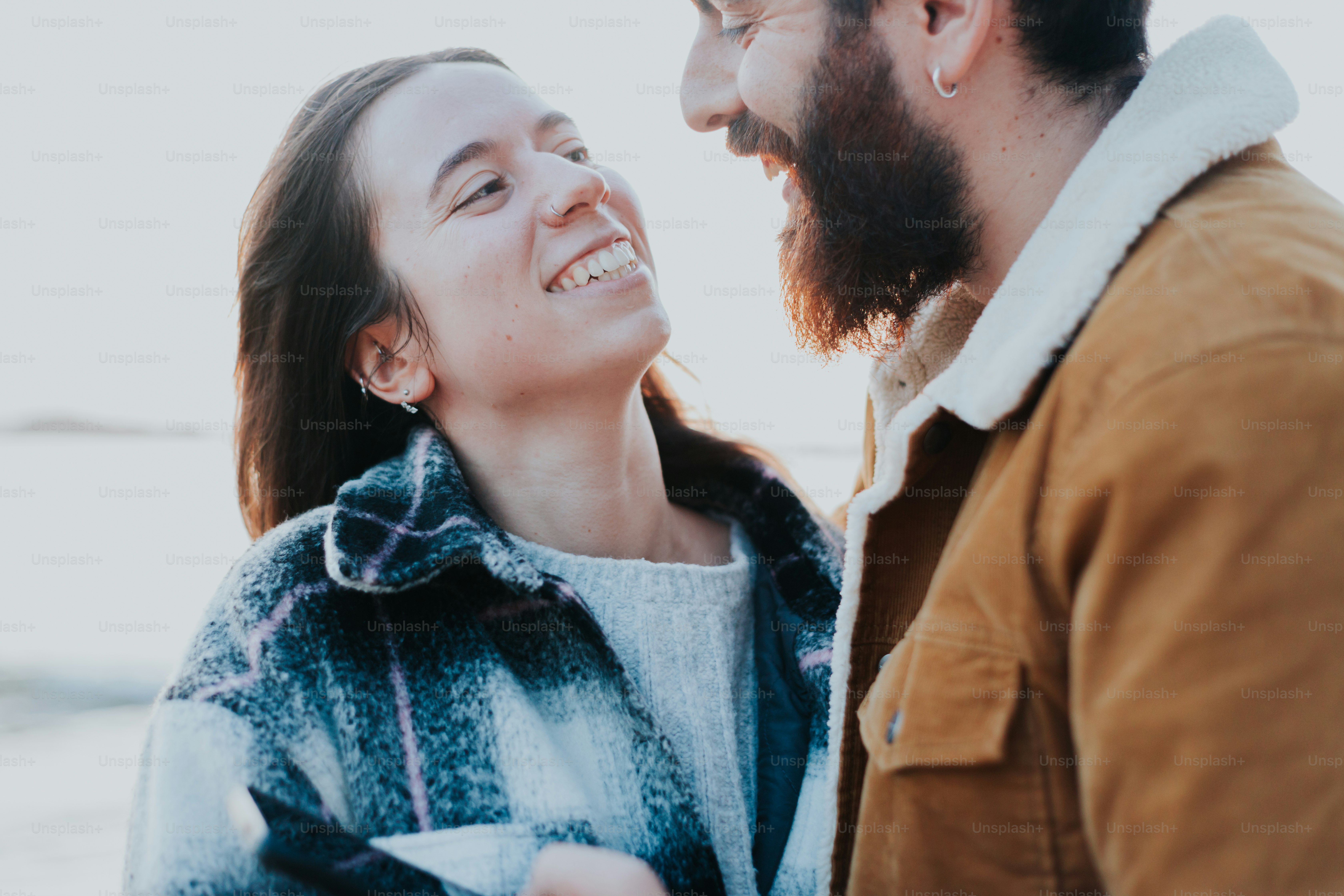 a man and a woman smile at each other