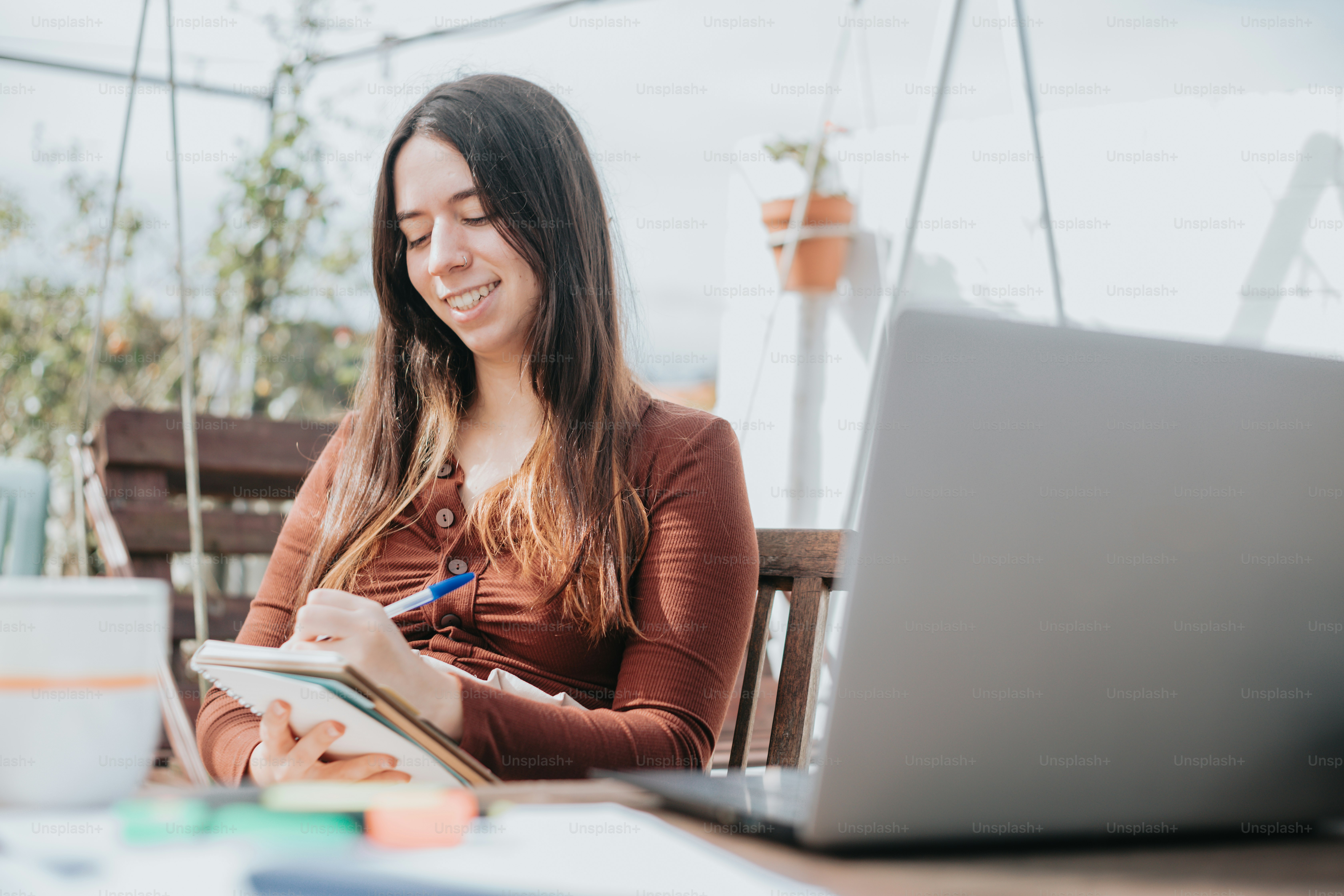 a woman sitting at a table with a laptop