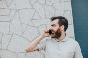 a man with a beard talking on a cell phone