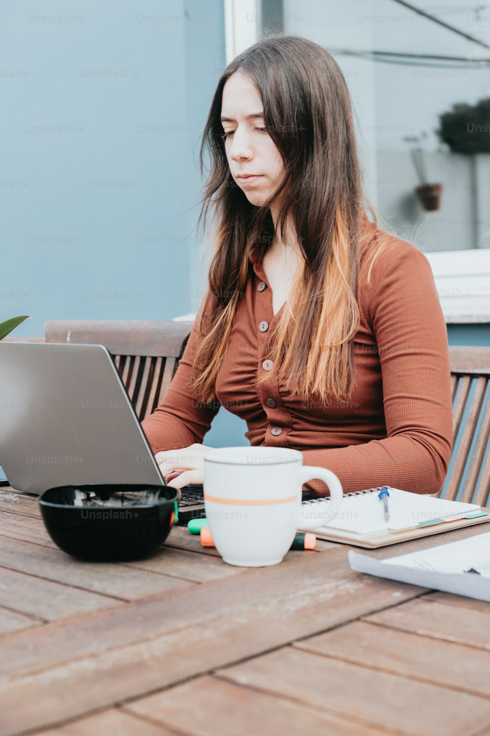 a woman sitting at a table with a laptop