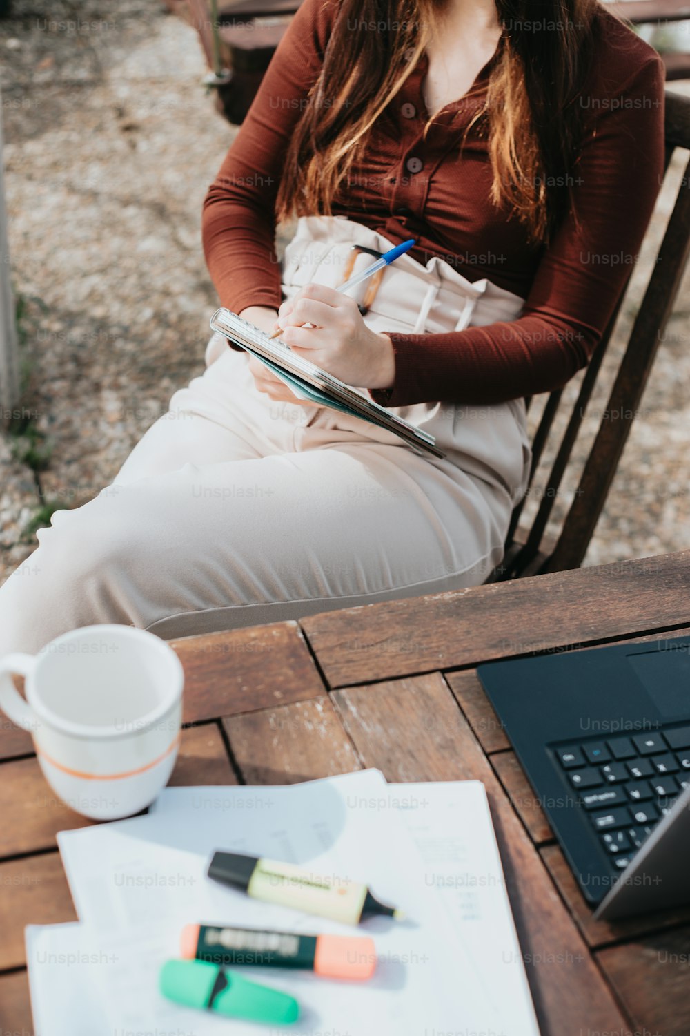 a woman sitting at a table with a laptop