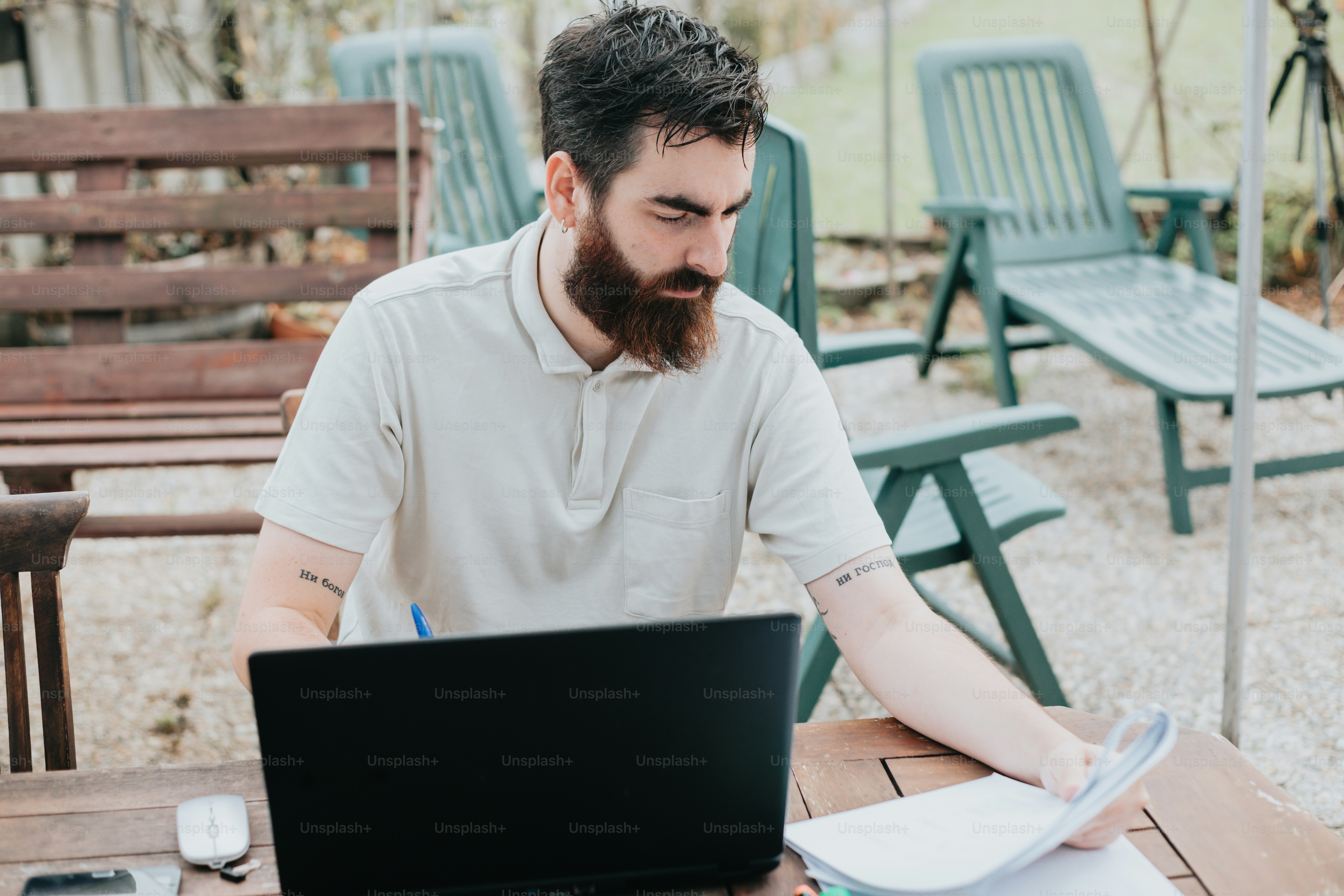 a man sitting at a table with a laptop