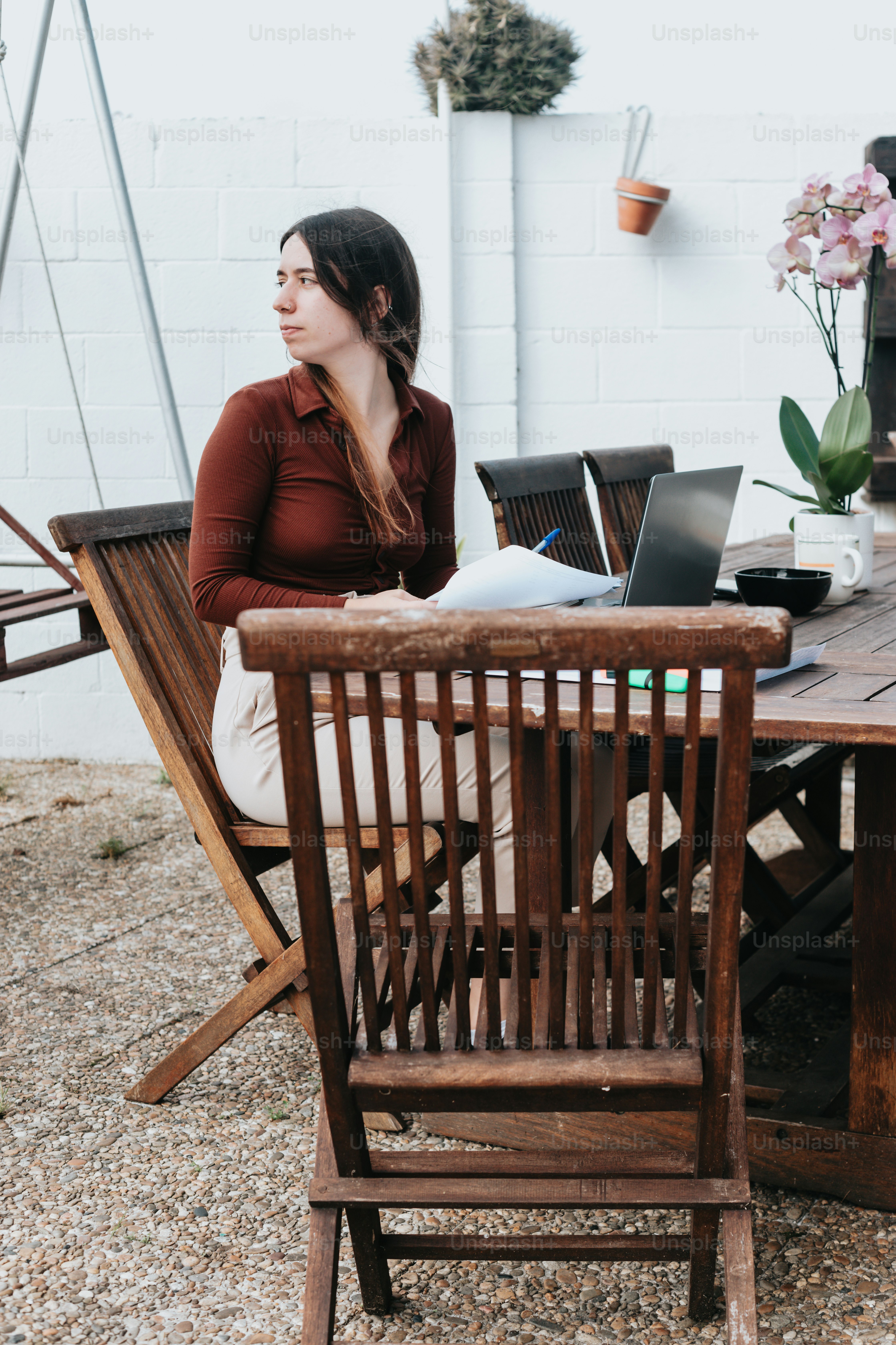 a woman sitting at a table with a laptop