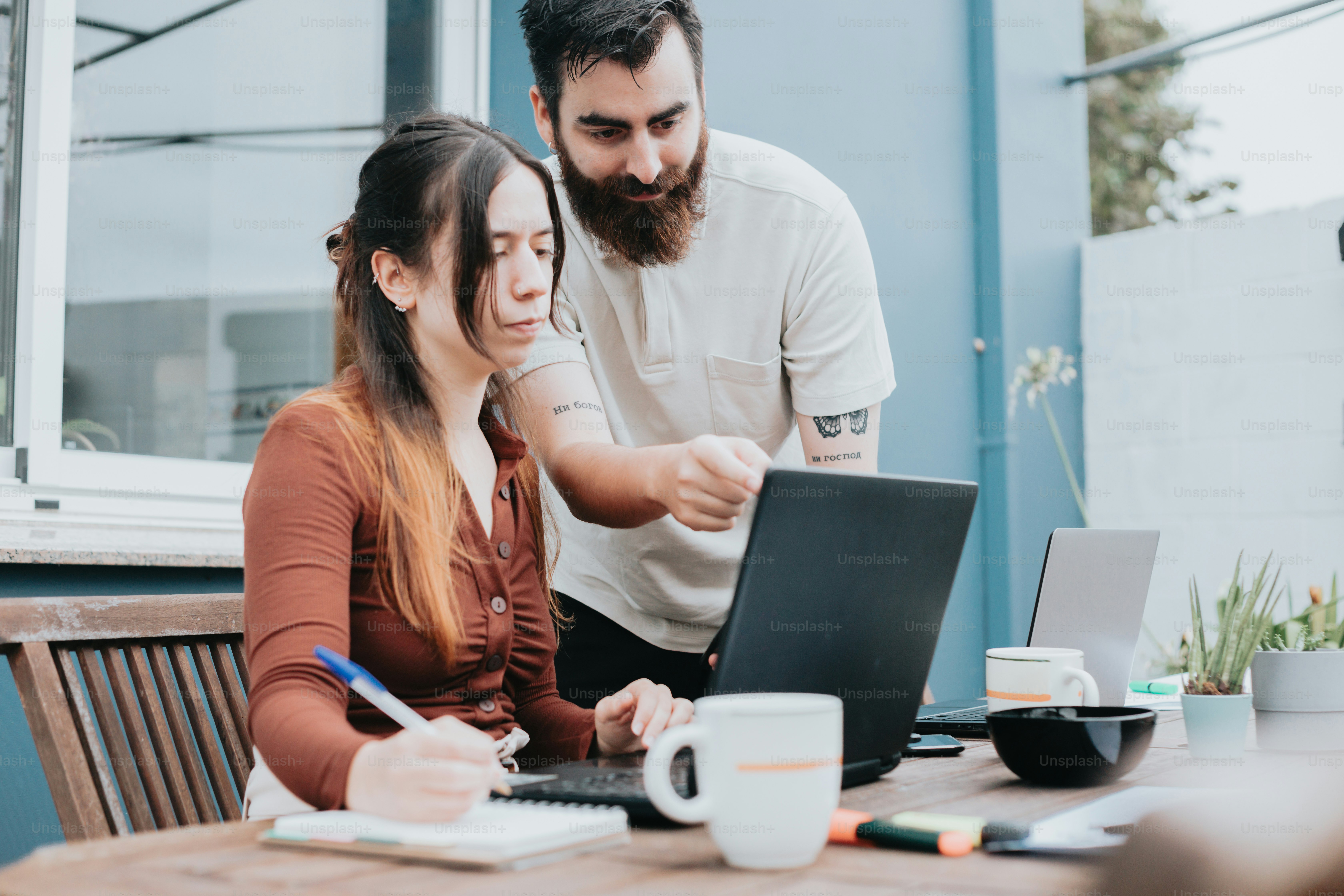 a man and a woman looking at a laptop