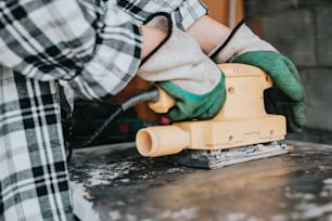 a person using a sander on a table