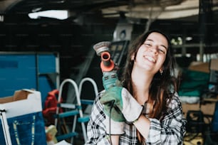 a woman holding a wrench in her right hand