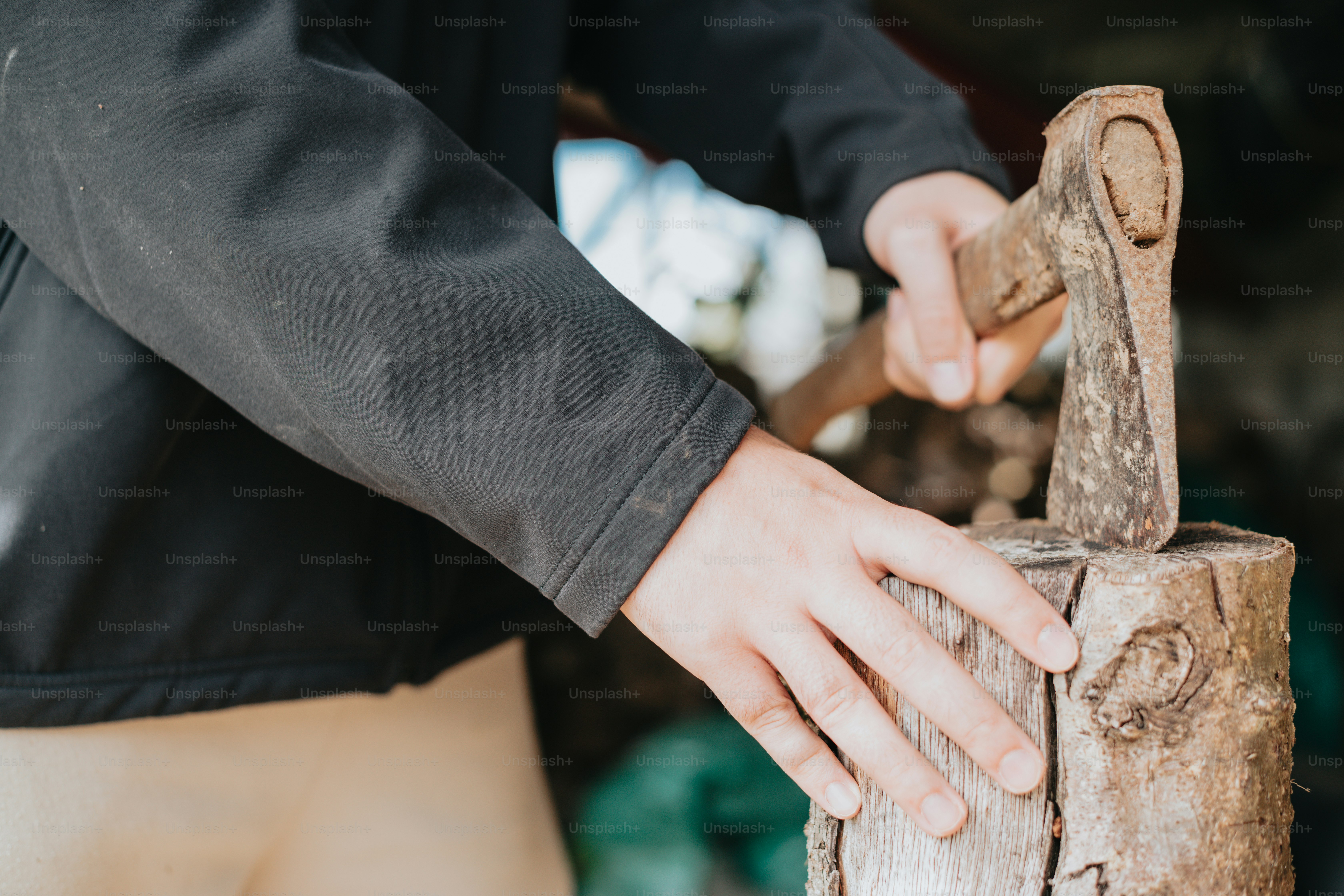 a close up of a person holding a piece of wood