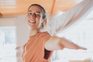 a woman is smiling and stretching her arms