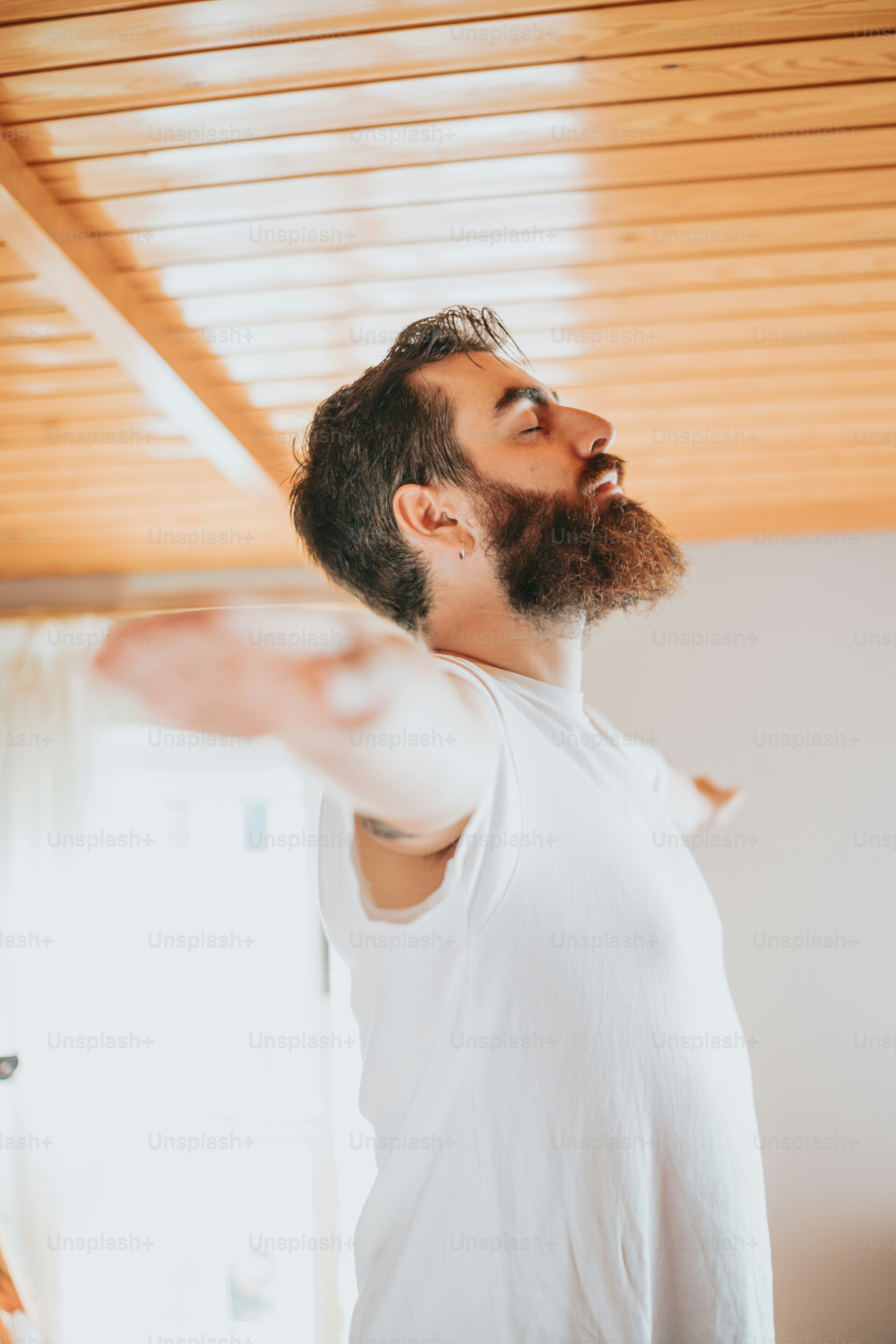 a man standing in a room with his arms out