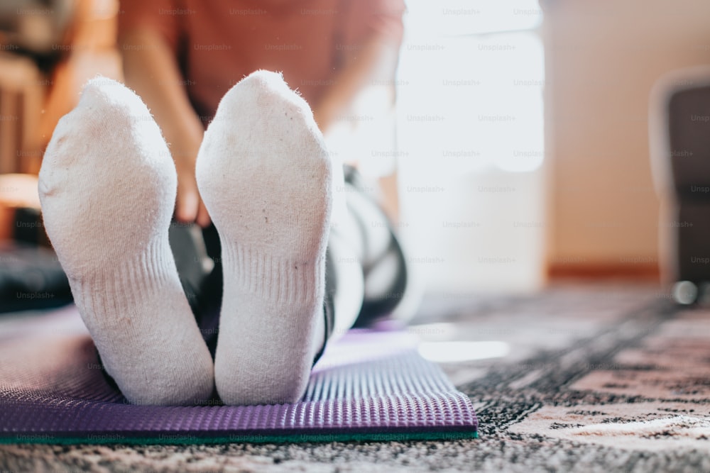 a person with their feet up on a mat