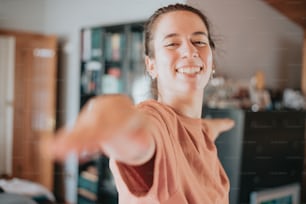 a woman is smiling and pointing at something