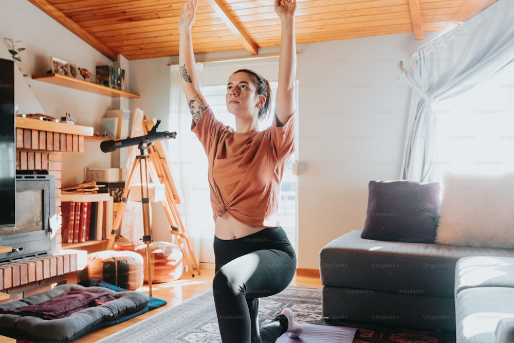 a woman is doing yoga in a living room