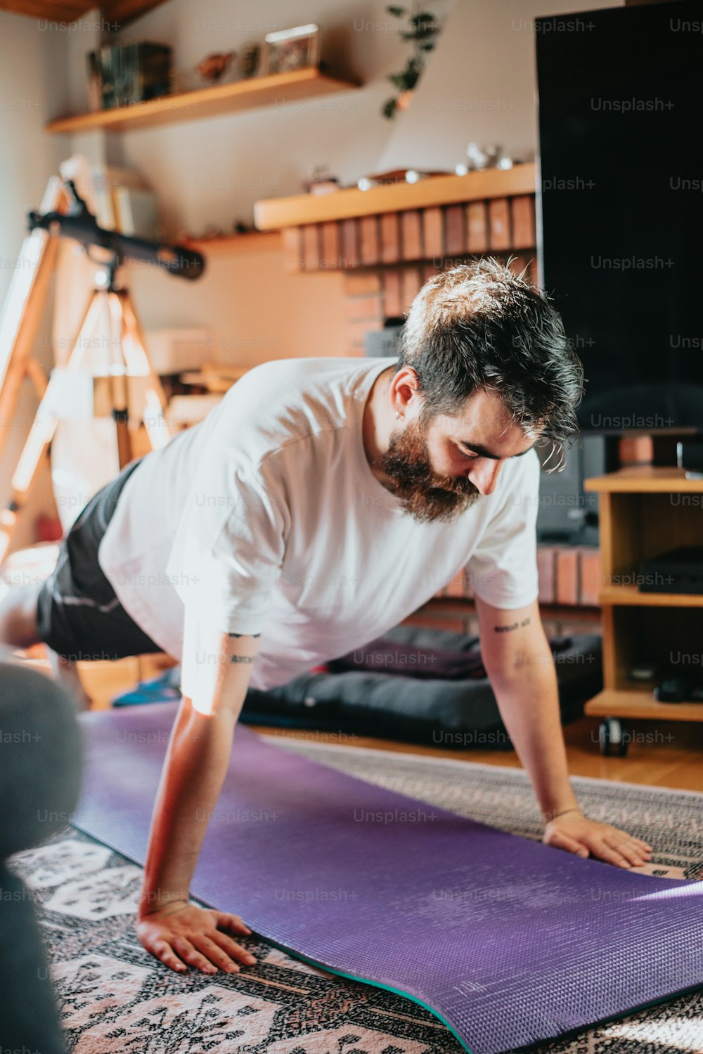 a man is doing yoga on a mat