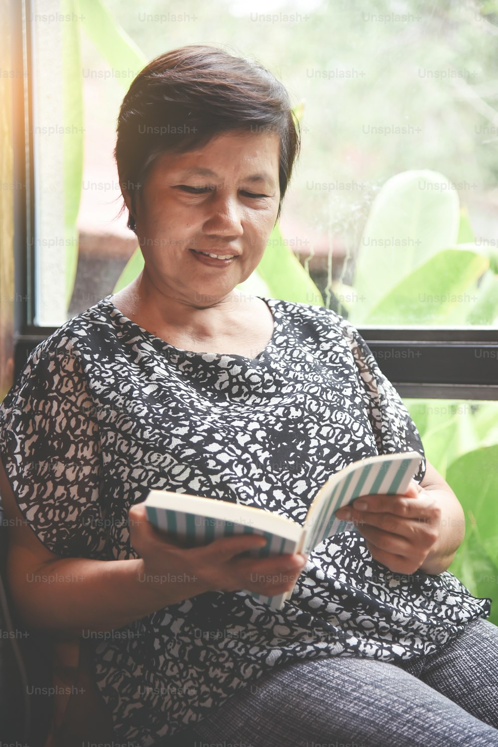 Happiness Asian senior woman reading a book.