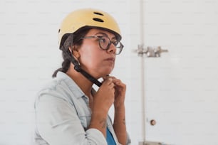 woman putting on a helmet to go out on a bicycle