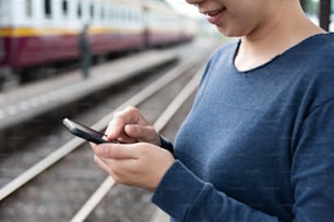 Young Asian Woman tourist using cell phone.