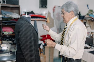 mature Mexican tailor working on local business