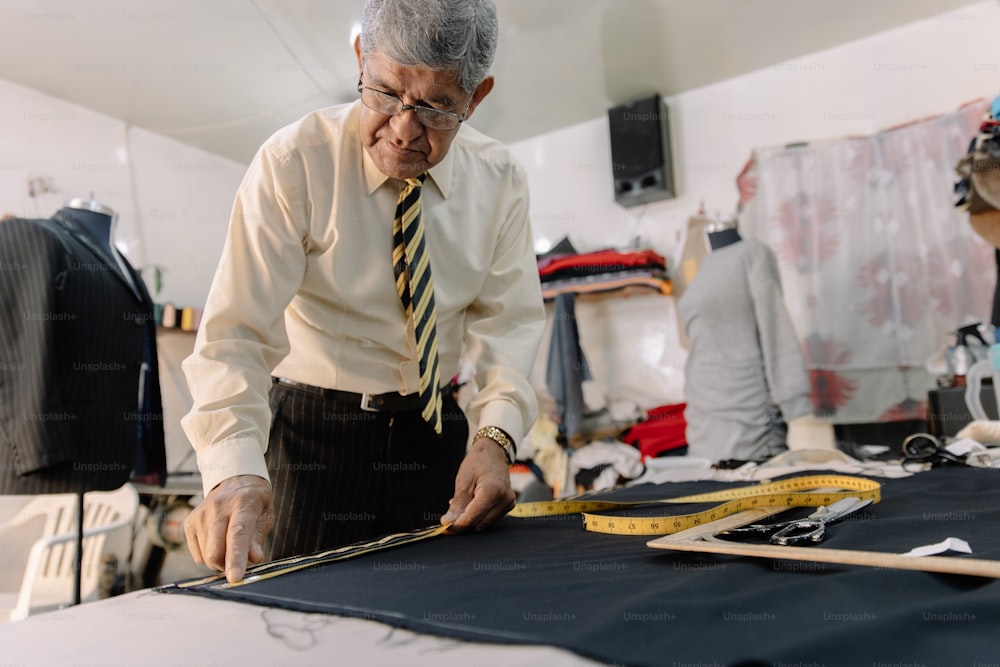 experienced Mexican tailor making strokes on fabric