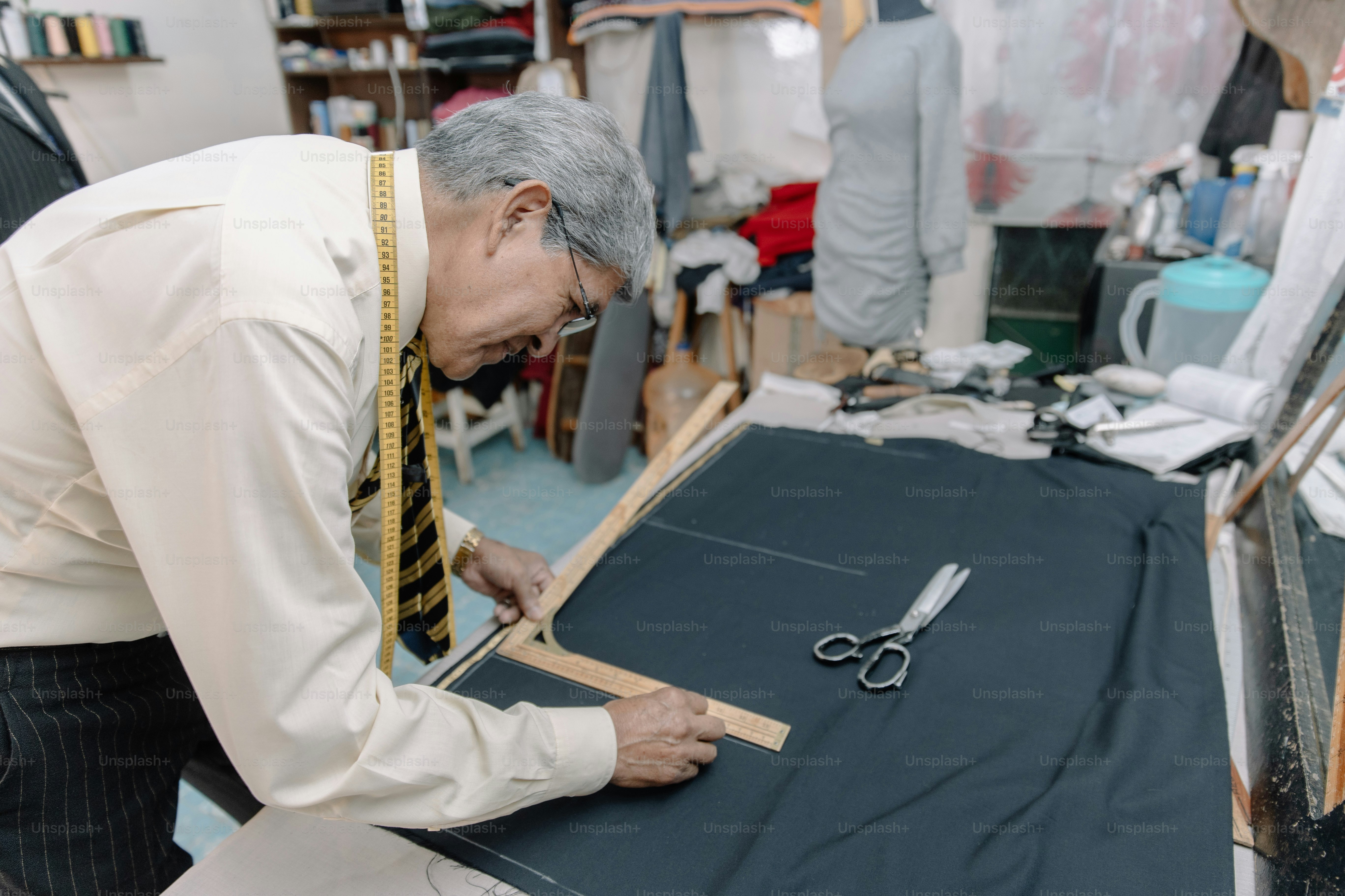 experienced mexican tailor making strokes on fabric