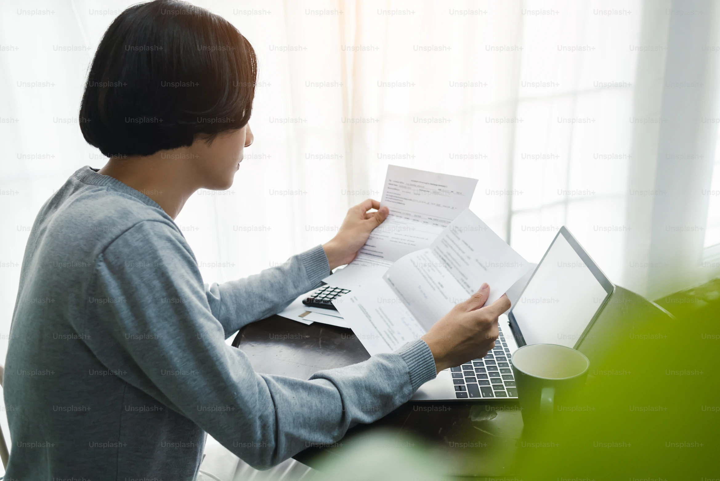 Person reviewing everyday spending and monthly household expenses