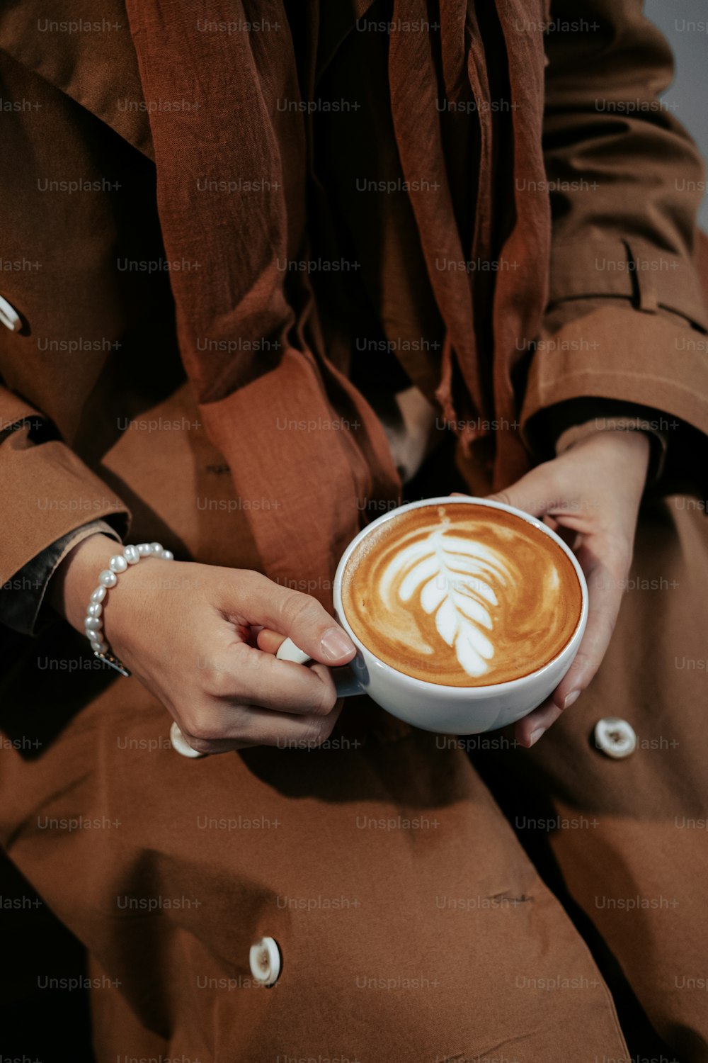 a person holding a cup of coffee in their hands