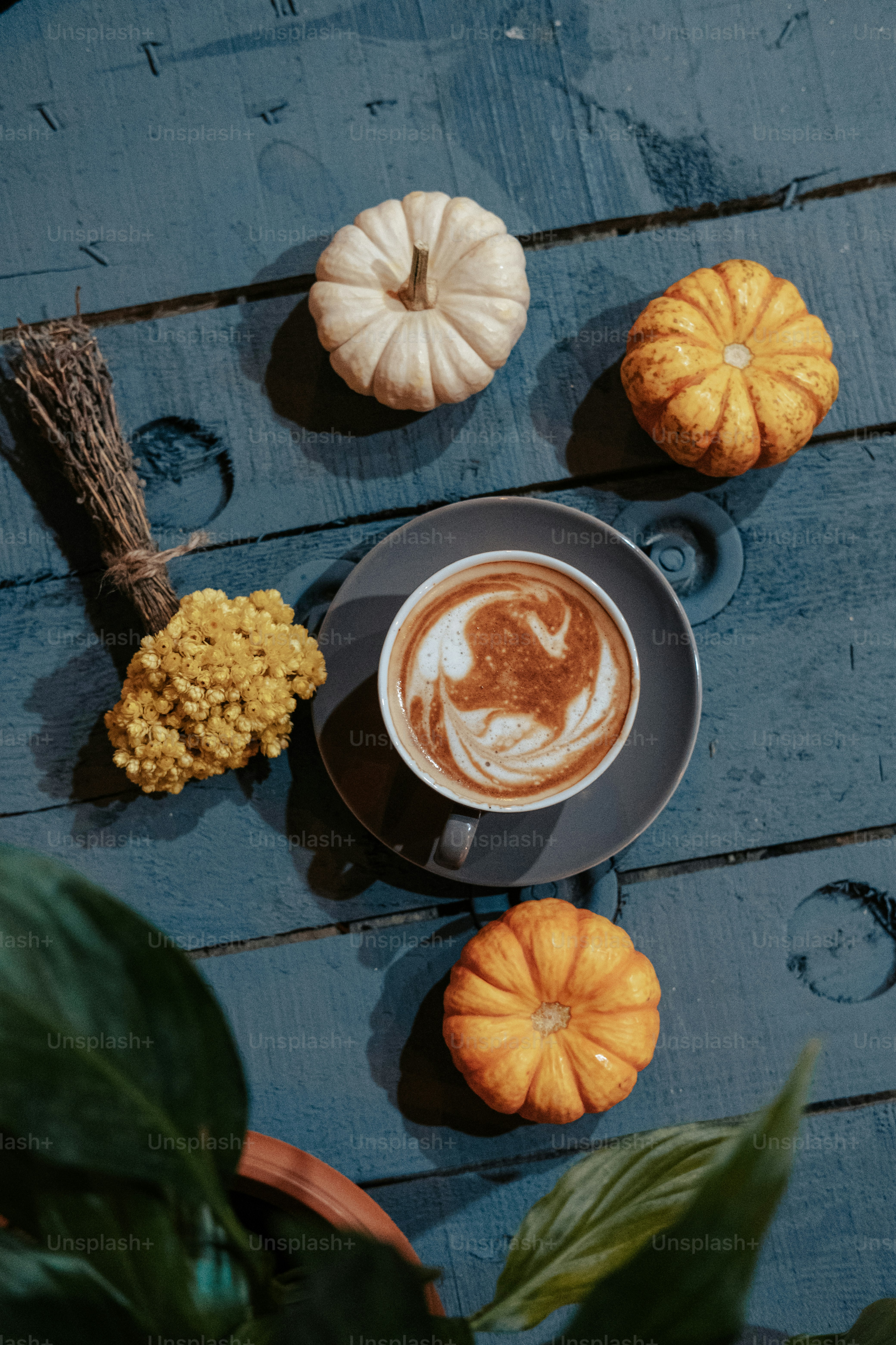 a cup of coffee sitting on top of a wooden table