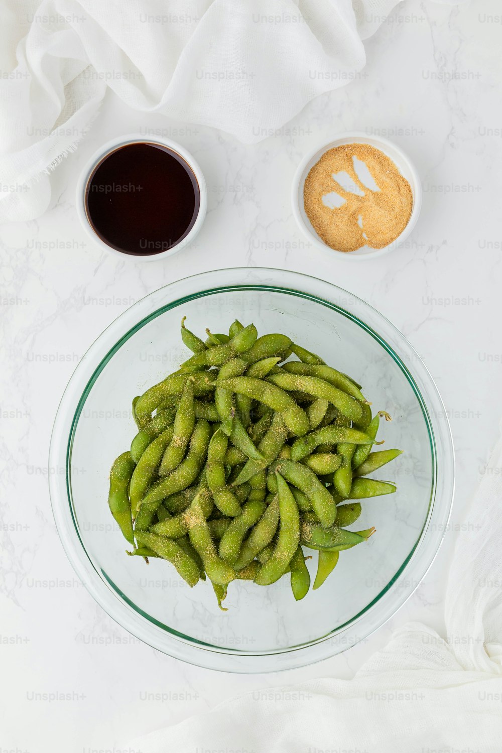 a plate of green beans next to a cup of coffee