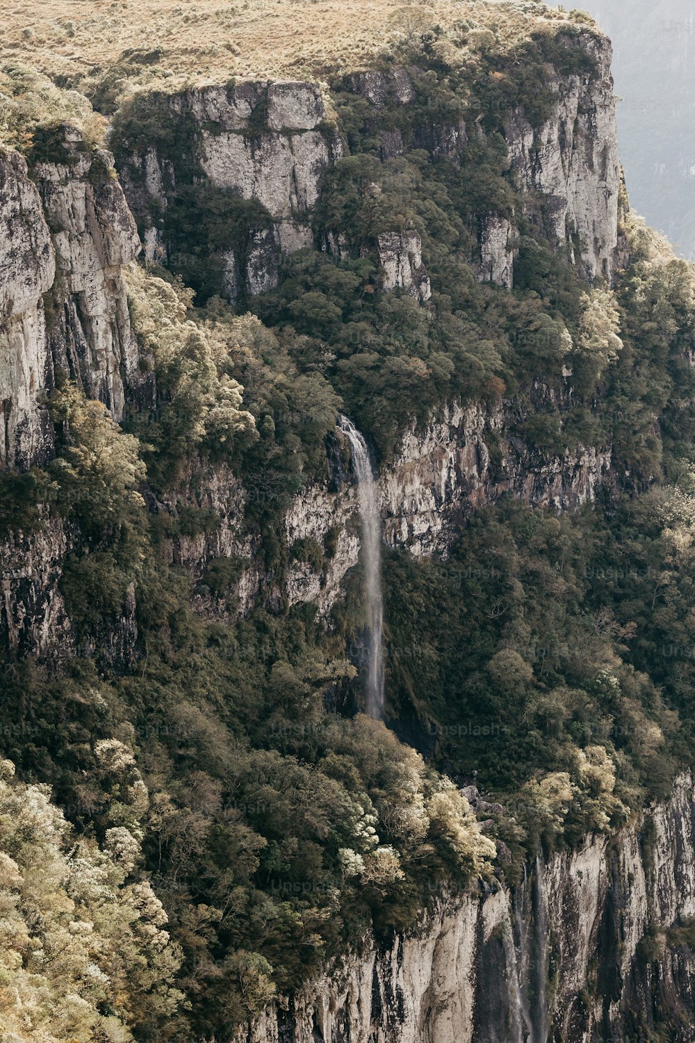 a waterfall in the middle of a mountain