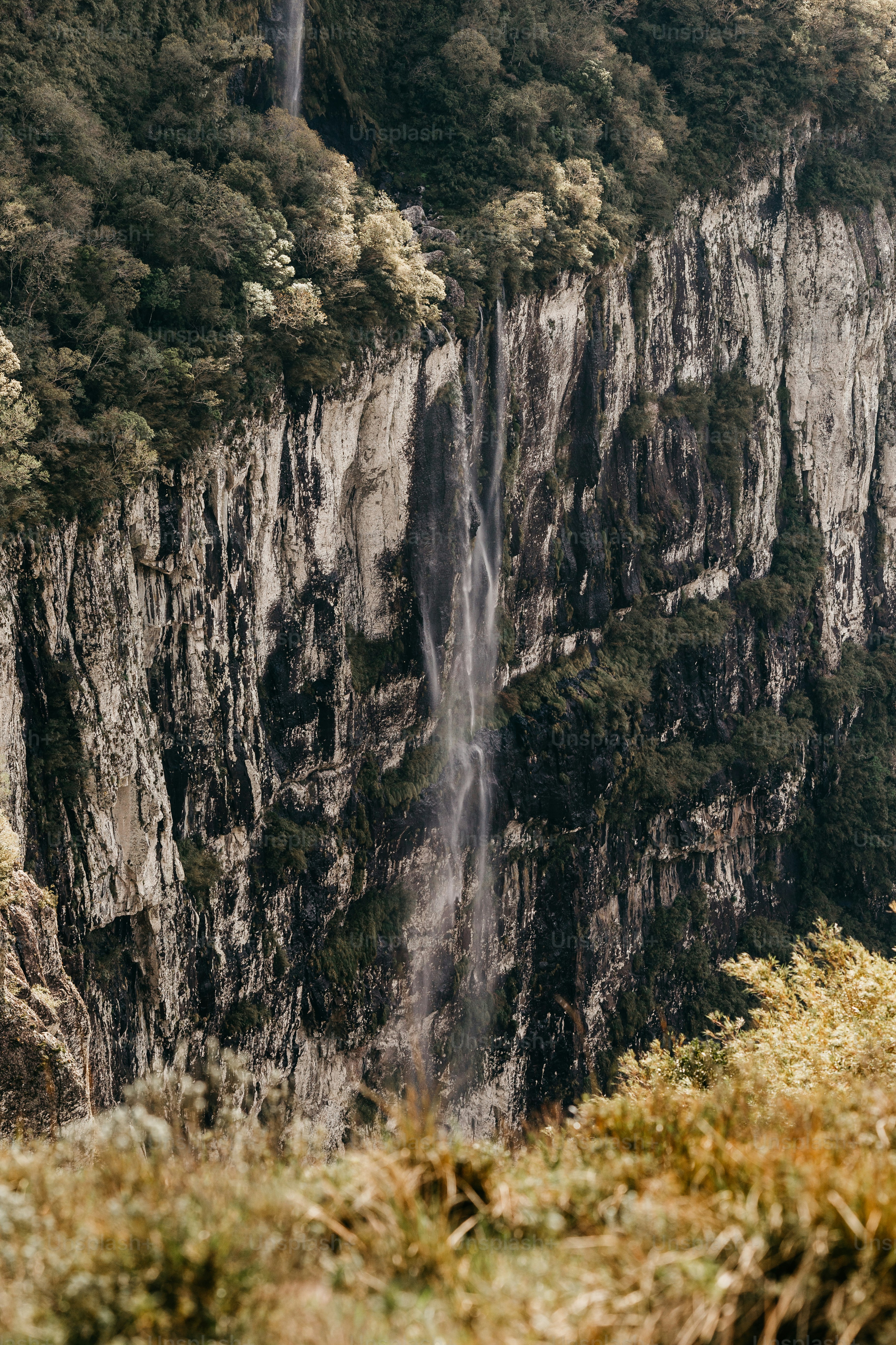 a large waterfall in the middle of a mountain