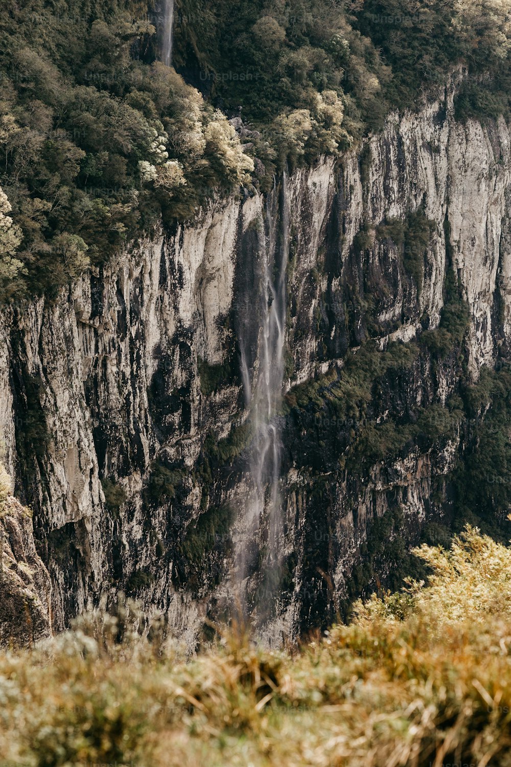 a large waterfall in the middle of a mountain