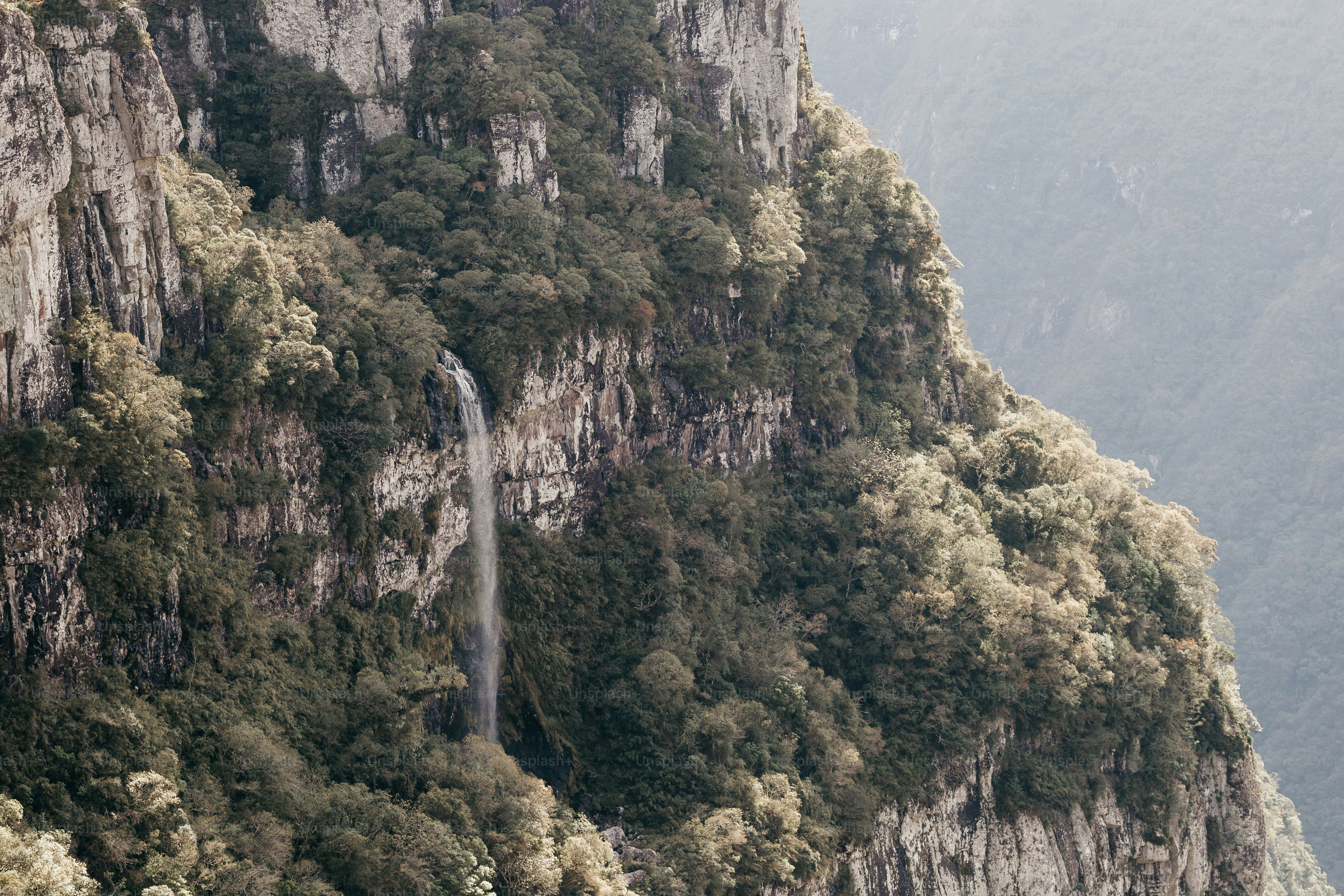 a mountain with a waterfall in the middle of it
