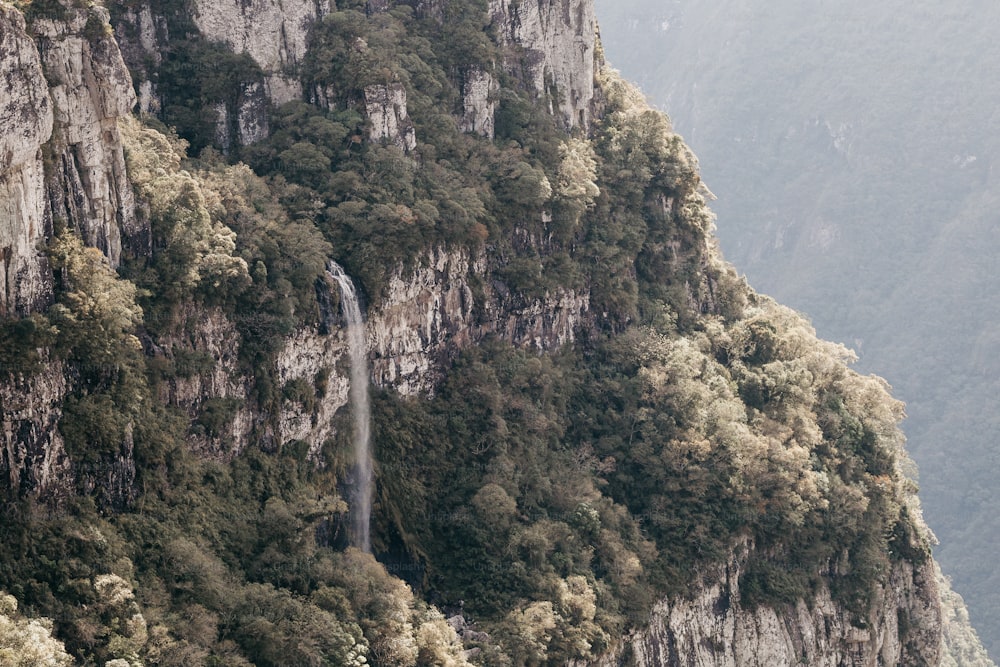 a mountain with a waterfall in the middle of it