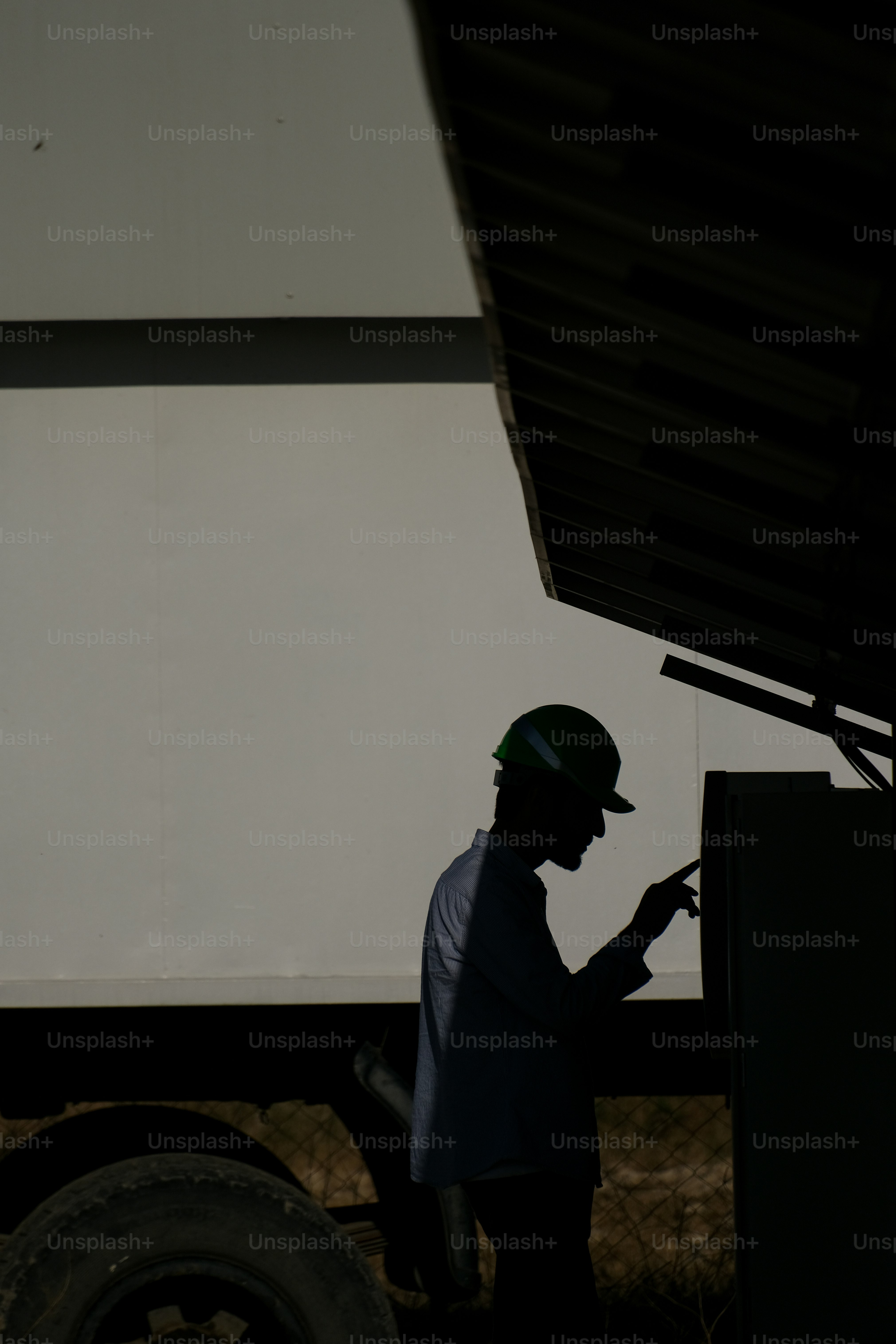 a man in a helmet standing next to a truck