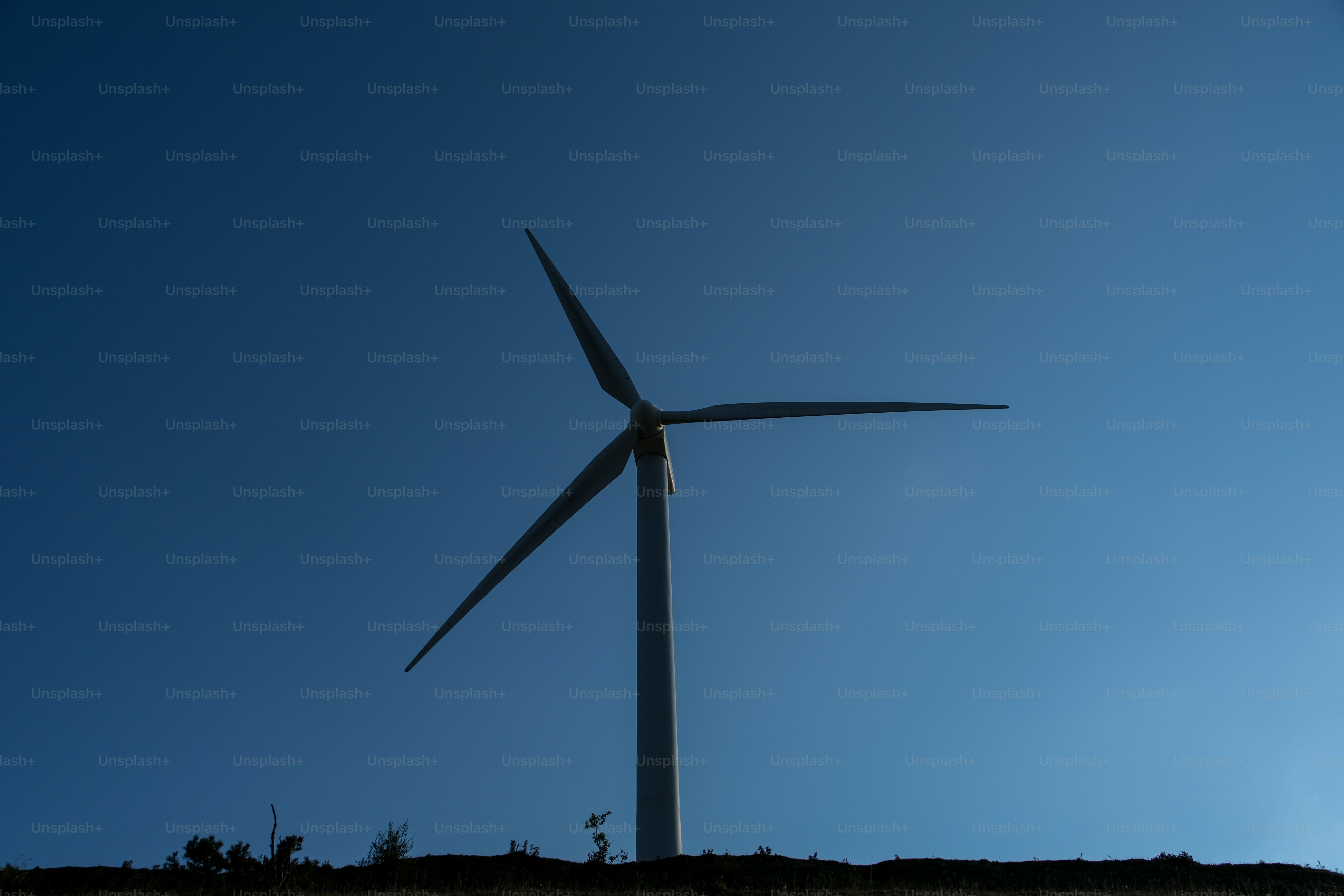 A group of wind turbines on a hill photo – Electricity Image on Unsplash