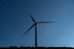 a wind turbine on top of a hill