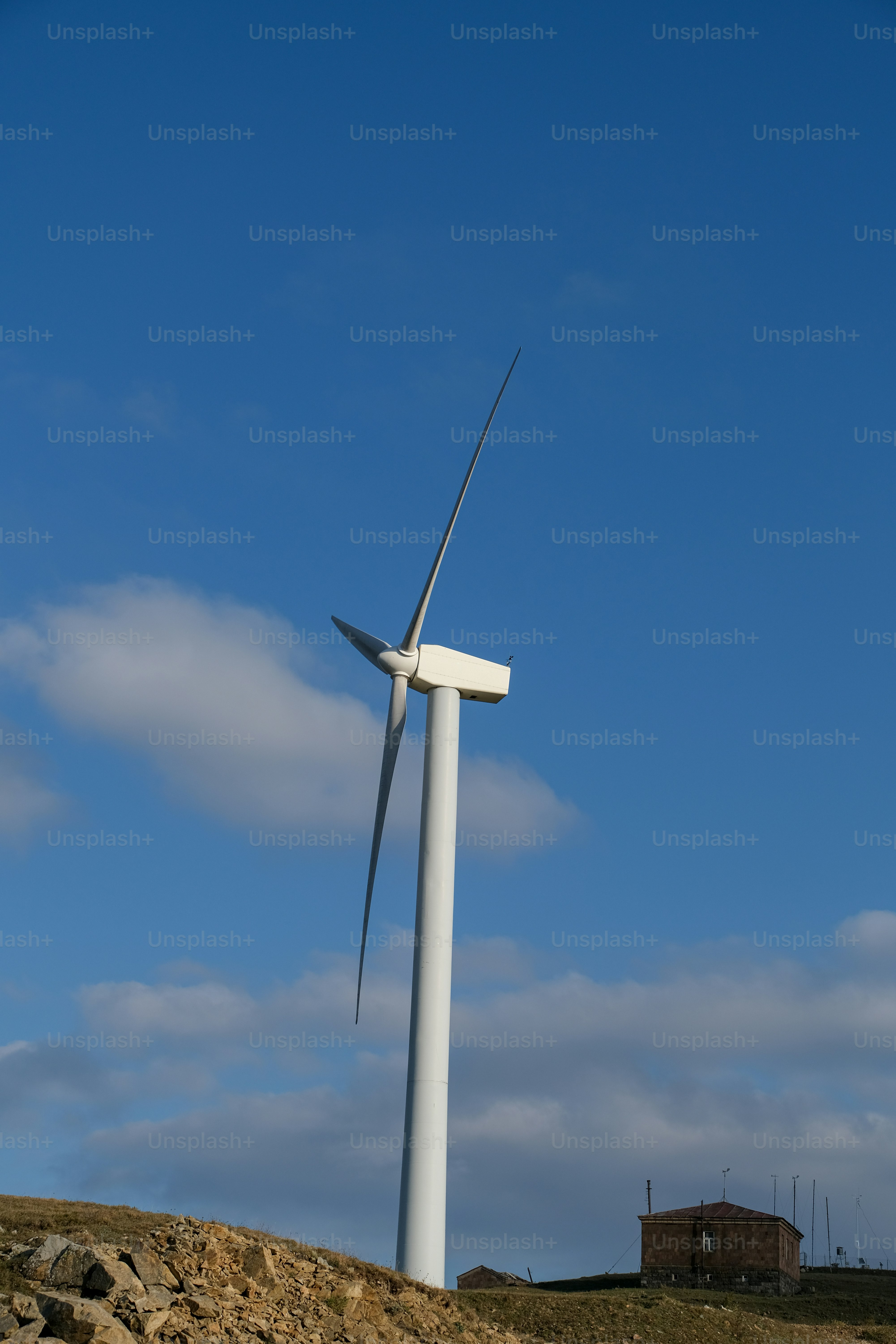 a wind turbine on top of a hill