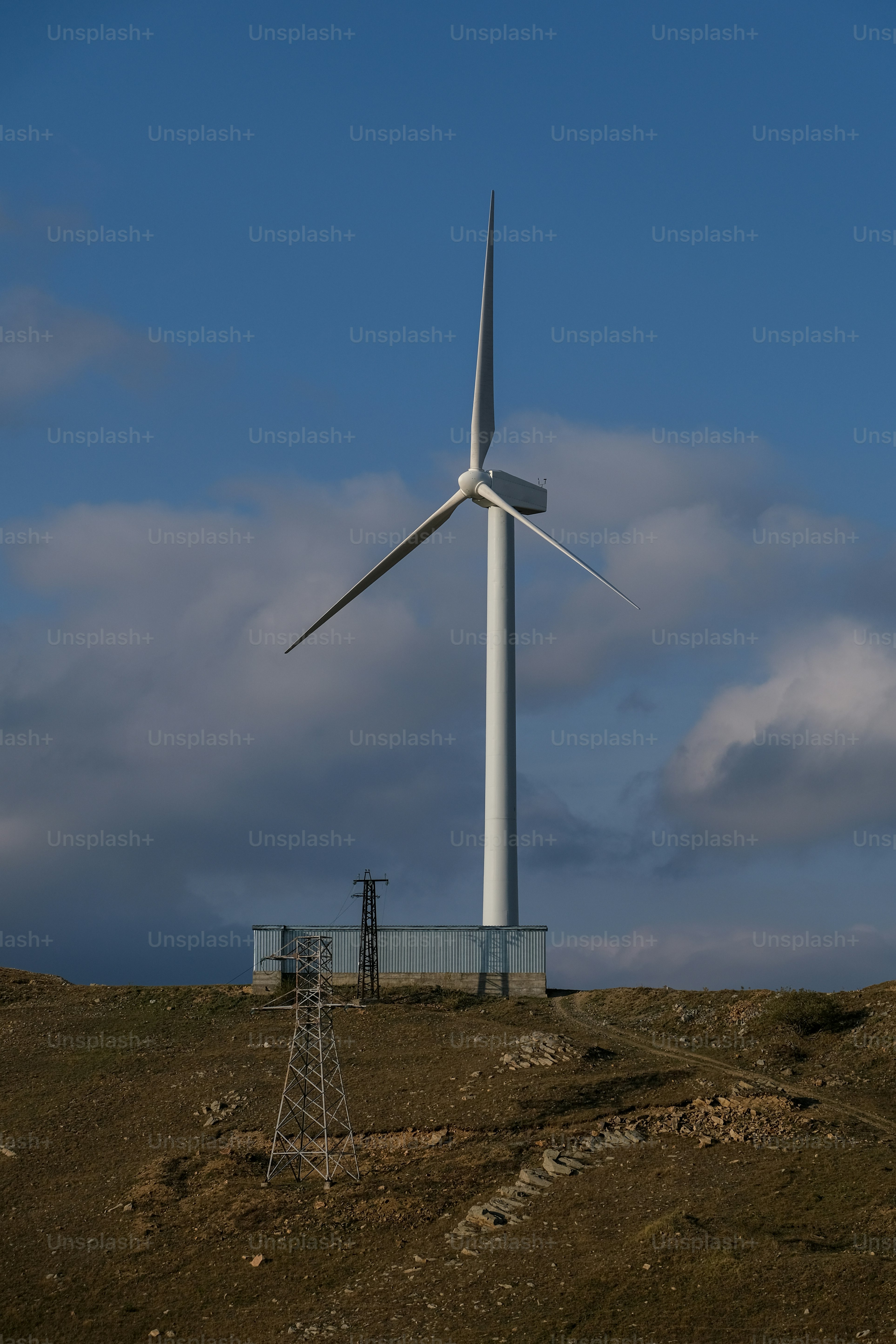 a wind turbine on top of a hill