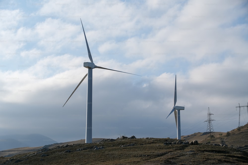 a group of wind turbines on a hill