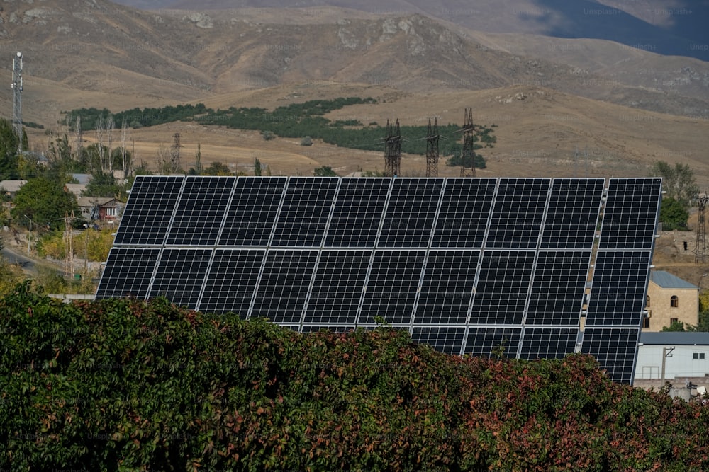 a large solar panel on top of a hill