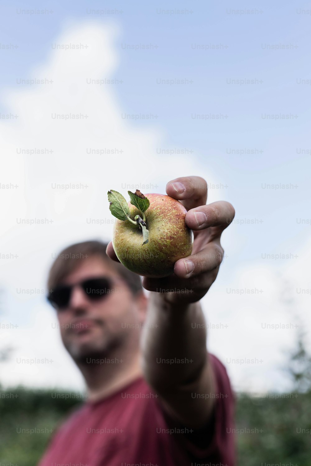 a man holding a green apple in his hand